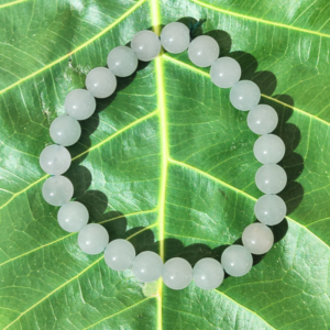 Green Aventurine Bracelet Resting on Sacred Fig Leaf