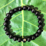 Black Tourmaline Bracelet Resting on Sacred Fig Leaf