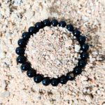 Black Tourmaline Bracelet Resting on Sand