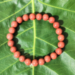 Red Jasper Bracelet Resting on Sacred Fig Leaf