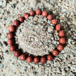 Red Jasper Bracelet Resting on Sand