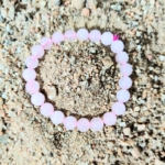 Rose Quartz Bracelet Resting on Sand