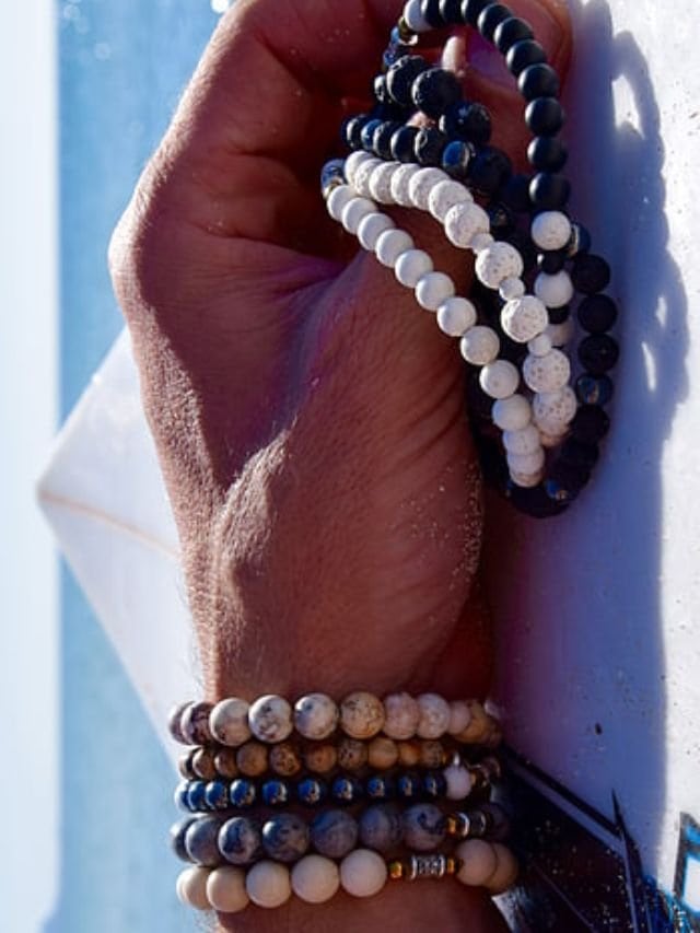 person wearing semi precious gemstone bracelets